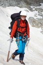 Backpacker girl with ice-axe Royalty Free Stock Photo