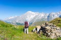 Backpacker hiking on the Alps, majestic Mont Blanc in background Royalty Free Stock Photo