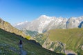 Backpacker hiking on the Alps, majestic Mont Blanc in background Royalty Free Stock Photo