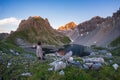 Backpacker hiking on footpath and looking at expansive view from the top. Summer adventures and exploration on the Italian French Royalty Free Stock Photo