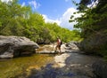 Backpacker hiking by the river. Royalty Free Stock Photo