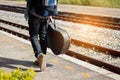 Backpacker is holding guitar case at railway station