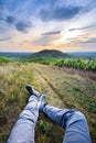 Backpacker legs at Mont Brouilly hill in vineyards, Beaujolais, France