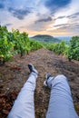 Backpacker legs at Mont Brouilly hill in vineyards, Beaujolais, France