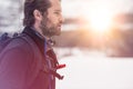 Backpacker man detail wearing anorak jacket. exploring snowy land walking and skiing with alpine ski. Europe Alps