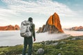 Backpacker man exploring sunset rocky mountains