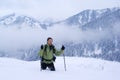 A backpacker man going in winter mountains Royalty Free Stock Photo