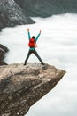 Backpacker Man jumping on Trolltunga rocky cliff edge Royalty Free Stock Photo