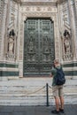 Florence ITALY - August 5, 2023 - Backpacker photographing the main gate of entrance of Santa Maria del Fiore cathedral