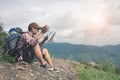 Backpacker man searching right direction on map.