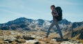 Backpacker on mountain travel adventure on landscape