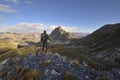 Backpacker observes the Alps Royalty Free Stock Photo