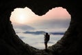 Backpacker outstretched hands in cave