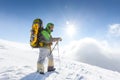 Backpacker is posing in winter mountains