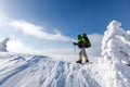 Backpacker is posing in winter mountains