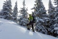 Backpacker posing in winter mountains