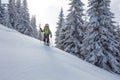 Backpacker posing in winter mountains