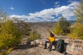 Backpacker reading map on forest trip while resting.