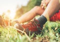 Backpacker`s trekking boots close up shot. Man has a rest break sitting on green grass and enjoying mountain walking, Active Royalty Free Stock Photo