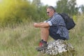 Backpacker sitting on a rock