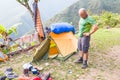 Backpacker standing tent morning mess gear disorder, camping mountains Bolivia. Royalty Free Stock Photo