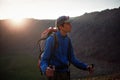 Backpacker in summer mountains