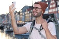 Backpacker taking a selfie in Nyhavn, Copenhagen, Denmark Royalty Free Stock Photo