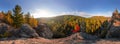 Backpacker on top of a rock fall at dawn. Cylindrical panorama 360 degrees Royalty Free Stock Photo