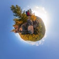 Backpacker on top of a rock fall at dawn. spherical degree panorama 360 180 little planet Royalty Free Stock Photo