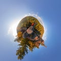 Backpacker on top of a rock fall at dawn. spherical degree panorama 360 180 little planet Royalty Free Stock Photo
