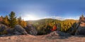 Backpacker on top of a rock fall at dawn. Spherical panorama 360 180 degrees equidistant Royalty Free Stock Photo