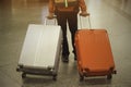 Backpacker tourist man holding luggage while situating at railway station. Royalty Free Stock Photo