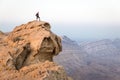 Backpacker tourist standing mountain cliff edge, landscape