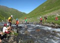 Backpacker tourists crossing river