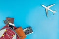 Backpacker travel accessories with plane on blue Royalty Free Stock Photo