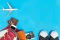 Backpacker travel accessories with toy plane on blue Royalty Free Stock Photo