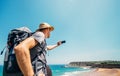 Backpacker traveler take photo beautiful ocean view with smartphone