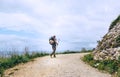 Backpacker traveler walks on road