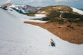 Backpacker in unicorn costume having fun in snowy mountains Royalty Free Stock Photo