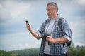 Backpacker using smart phone Royalty Free Stock Photo
