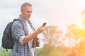 Backpacker using smart phone Royalty Free Stock Photo