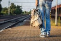 Backpacker waiting for train at railway station Royalty Free Stock Photo