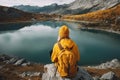 Backpacker woman with backpack enjoying the turquoise mountain lake. AI Generative