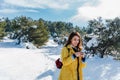 backpacker woman hiking outdoors in snowy mountain. Using mobile phone. Nature, technology and lifestyle