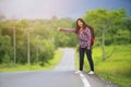 Backpacker woman hitchhiking on the road