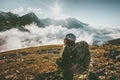 Backpacker woman observing mountains clouds