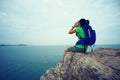 Backpacker yelling on seaside mountain top cliff Royalty Free Stock Photo