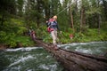 Backpackers are crossing mountain river