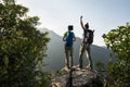 Backpackers enjoy the view on cliff edge Royalty Free Stock Photo