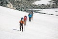 Backpackers are passing snow field in rocky mountain in Altai mo